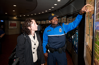 MTPD officer assists Metro rider with directions.