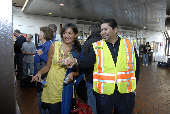 A Metrorail station manager at the Ronald Reagan National Airport Metrorail station offers directions to a visitor.