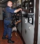 MTPD K9 officer inspects fare vending machines at Metro station.