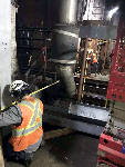 Before installing the steel frame over the tracks, workers performed with both laser and hand measurements. Here, workers hand measure steel column locations on each side of the tracks.
