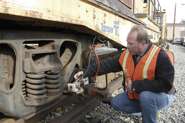 A Metrorail employee adjusts a rail de-icer to prepare for inclement winter weather.